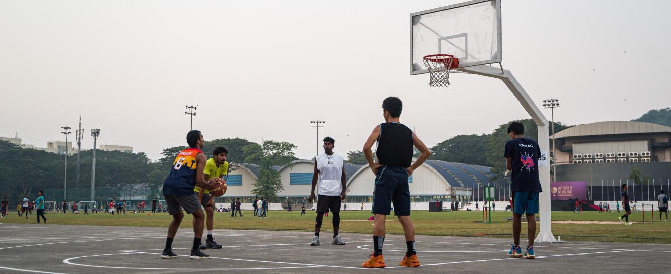 Students playing basketball at the outdoor court