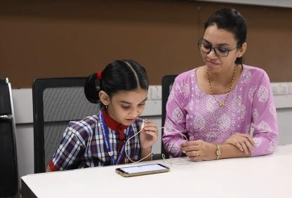 Teacher Facilitating the test of a student (Credits: Researchers)